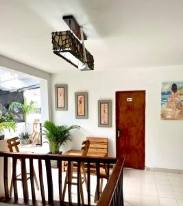 a dining room with a table and a red door at Habitación cerca de la playa 203 in Cartagena de Indias