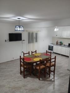 a kitchen with a table and chairs in a room at Km 9 in Viedma