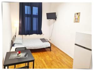 a small room with a table and a refrigerator at SouvenirAppart Sniadeckich in Bydgoszcz