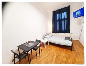 a small room with a table and a bed at SouvenirAppart Sniadeckich in Bydgoszcz