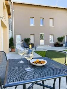 a table with two wine glasses and a plate of food at CaVecchie Desenzano in Desenzano del Garda