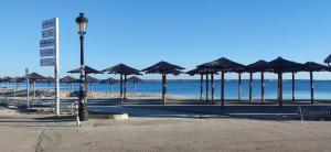 a group of umbrellas on a beach with the ocean at Fewo Saric Vir in Vir