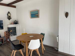 a dining room with a wooden table and chairs at sport et repos à Leysin CH in Leysin