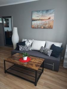 a living room with a couch and a coffee table at Apartament Szept Plaży in Kołobrzeg
