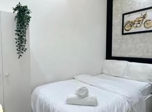 a bedroom with a white bed with a plant on it at Attraction Partition Room in Barsha heights Tecom in Dubai +43 photos