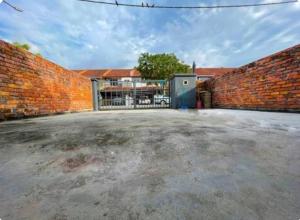 a brick wall with a gate and a building at LSH Homestay Rawang in Rawang