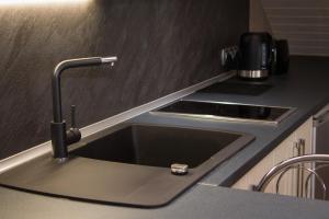 a kitchen counter with a sink and a stove at Romance in Ventspils +86 photos