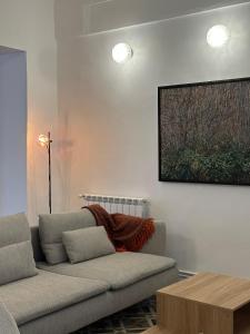 a living room with a couch and a picture on the wall at Apartamento El Tozal in Teruel