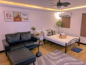 a living room with a couch and a table at The Bachelor in Cabanatuan