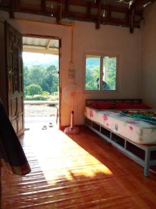 a bedroom with a bed and a window at Abu Sea Man House in Ko Lanta Yai