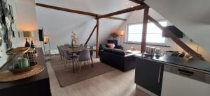 a kitchen and living room with a table and chairs at Haus Blick am Edersee in Waldeck