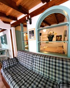 a couch in a living room with a large window at Baglio Del Sole in San Vito lo Capo