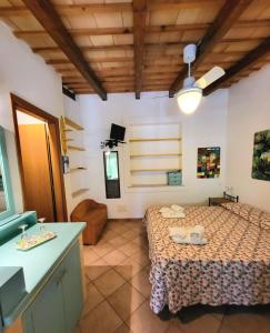 a bedroom with a bed and a sink in a room at Baglio Del Sole in San Vito lo Capo