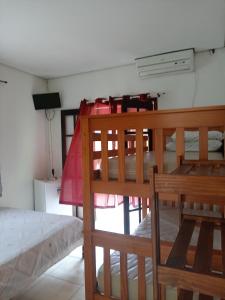 a bedroom with two bunk beds in a room at Belo Suítes in Ubatuba