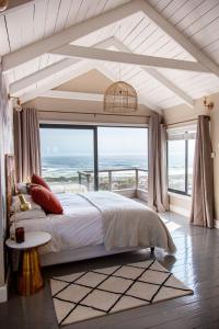 a bedroom with a large bed and a large window at Sunset Villa in Scarborough