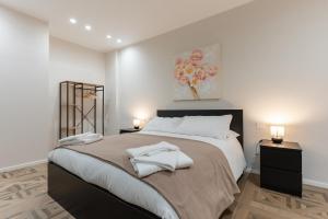 a bedroom with a large bed with two night stands at Mica Home Calefati in Bari