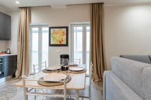 a living room with a table and a couch at Mica Home Calefati in Bari