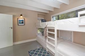 a couple of bunk beds in a room with a window at Sunset Villa in Scarborough +51 photos