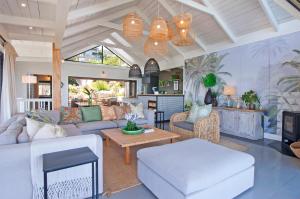 a living room with a couch and a table at Sunset Villa in Scarborough