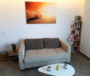 a living room with a couch and a table at Sweet Home Nikorenia 1 in Krotiri