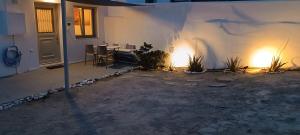 a patio with a table and chairs and a building at Sweet Home Nikorenia 1 in Krotiri