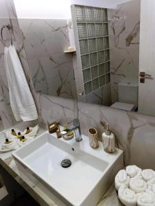 a white bathroom with a sink and a mirror at Sweet Home Nikorenia 1 in Krotiri +38 photos