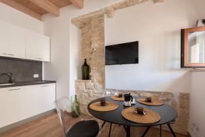 a dining room with a table and two chairs at Palazzo Rizzi Dimora dei Templari in Bitetto