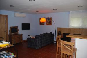 a living room with a couch and a tv at Apartment near Bilbao L-Bi-57 in Gatica