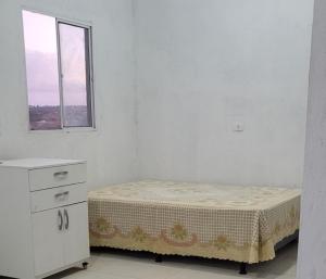 a small bed in a white room with a window at Marina's in Pau dʼAlho