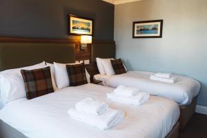 Posteľ alebo postele v izbe v ubytovaní The Portree Hotel
