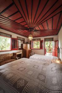 a bedroom with a large bed with a wooden ceiling at Finca Hotel in Armenia