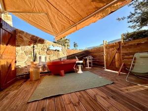 a red bath tub sitting on a deck at Superbe Maison - Bain Chaud ou Froid & Cinema - Cap d'Agde in Cap d'Agde