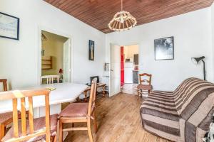 a living room with a table and a dining room at Maison charmante à Soulac-sur-Mer avec jardin clôturé in Soulac-sur-Mer