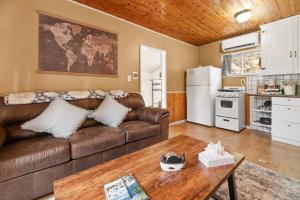 a living room with a couch and a table at Hideaway Cabin - Cozy romantic cabin perfect for couples in Big Bear City +6 photos