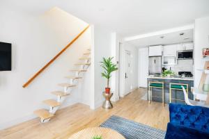 a living room with a staircase and a kitchen at 1597-PHN PH Duplex -Private Outdoor 2bath in New York +22 photos