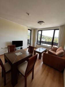 a living room with a table and a couch at Apartment Geronimo in Pamporovo