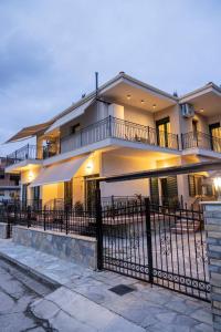 a large building with a fence in front of it at Filoxenia Luxury apartments Trikala in Tríkala
