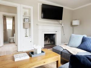 a living room with a couch and a fireplace at Spring Street Suites in Evansville
