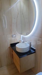 a bathroom with a sink and a mirror at Bel appartement familial résidence sécurisée in Casablanca +19 photos