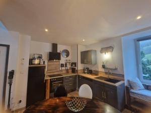a kitchen with a table and a counter top at Appartement duplex beaucens in Beaucens