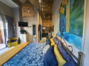 a bedroom with a bed with a blue comforter at Serenity 465 in De Kelders