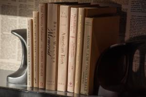 a group of books sitting on a shelf at Holiday Inn Express South Burlington - Downtown by IHG in Burlington