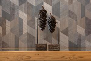 two plants in vases on a table with a wall at Holiday Inn Express South Burlington - Downtown by IHG in Burlington