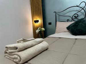 a bedroom with a bed with a blanket on it at La balena bianca house in Bagni San Filippo