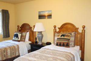 a bedroom with two beds and a lamp at Unit 102, 2 Bedroom Duck Lake Condo in Eagle River