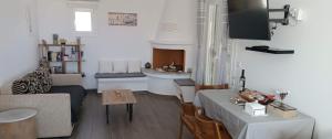 a living room with a table and a sink at Sweet Home Nikorenia 2 in Krotiri