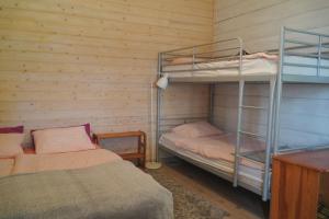 two bunk beds in a room with wooden walls at Domki nad jeziorem Węgorzyno in Augustowo +6 photos
