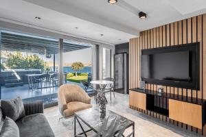 a living room with a tv and a couch at Çimentepe Residence Deluxe 2 - Villa with Jacuzzi in Yalikavak in Bodrum City