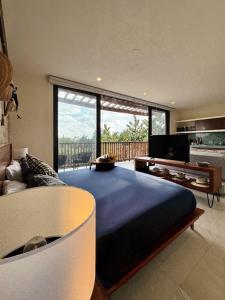 a large bedroom with a large bed and a couch at BOHO Loft Steps from the Beach in Holbox Island