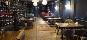 a restaurant with tables and chairs in a room at Tsaghkunk Chef House Hotel & Restaurant in Sevan